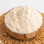 Fresh whole wheat atta flour in a wooden bowl with wheat grains – 1 kg pure wheat flour for roti and chapati